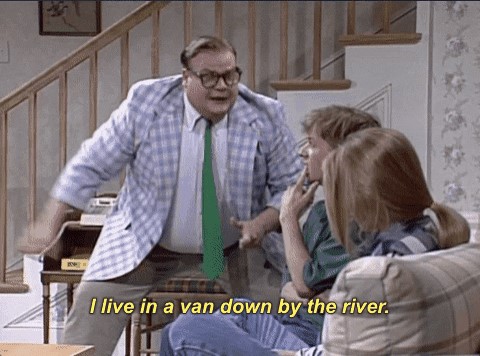 Picture of Chris Farley saying "I live in a van down by the river".